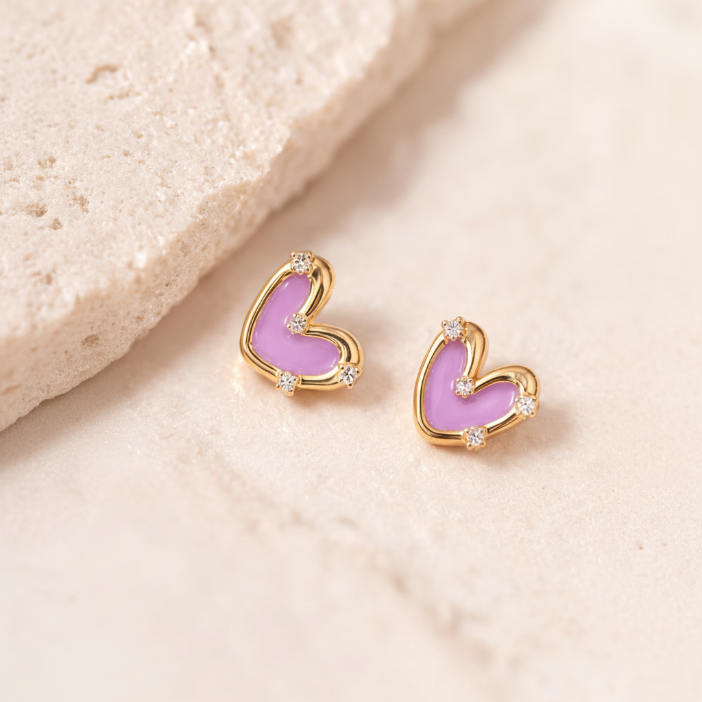 Heart-shaped earrings with pink hearts and gold frames on a beige background