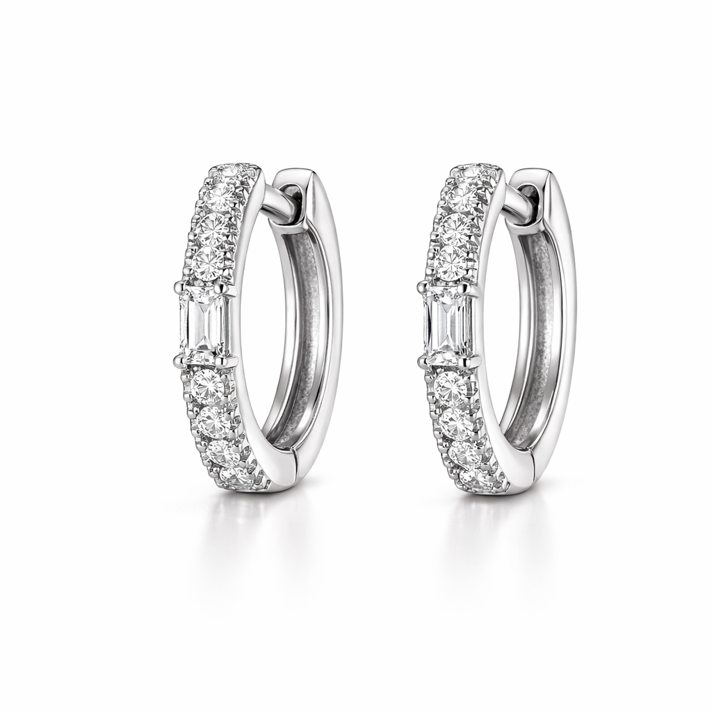 Pair of silver hoop earrings with clear gemstones on a white background