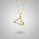 Gold necklace with a white pendant shaped like a horse in a carriage on a white fabric background